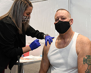 Geoff Beausoleil, manager of the NNSA Production Office, receives his COVID‑19 vaccination.